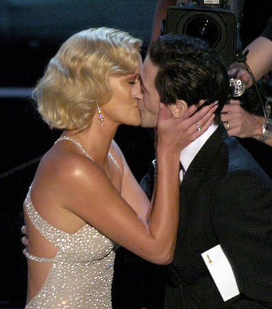 Presenter Adrien Brody kisses Charlize Theron after presenting her with the best actress award for her role in Monster at the 76th annual Academy Awards, Los Angeles, February 29, 2004.
